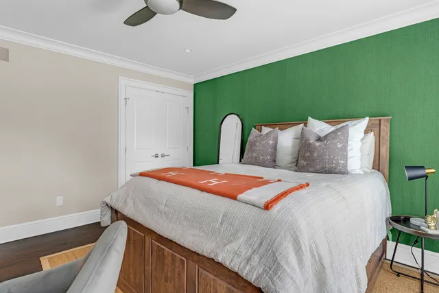 a bedroom with a bed and a potted plant