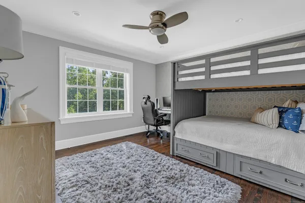 a bedroom with a bed dresser and a window