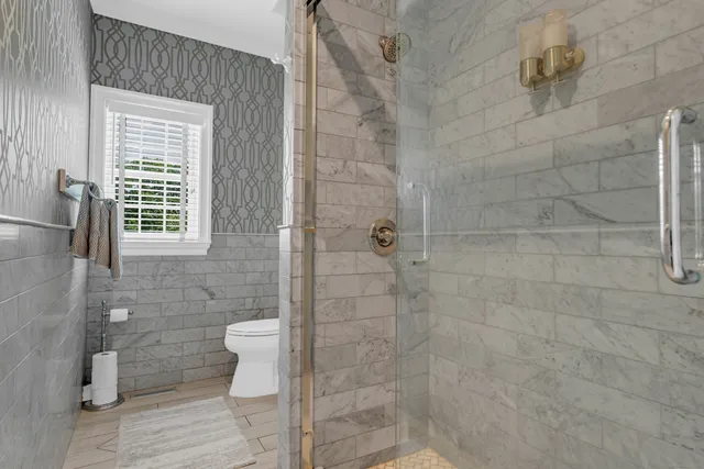 a bathroom with a toilet and a shower