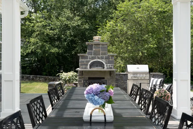 a view of a chairs and table in the balcony