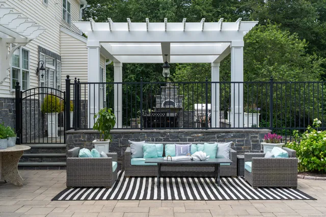 a view of a patio with couches table and chairs and potted plants