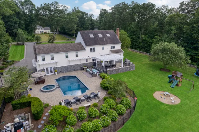 an aerial view of a house with garden space and street view