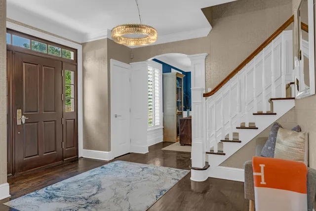 a view of entryway and hall with wooden floor