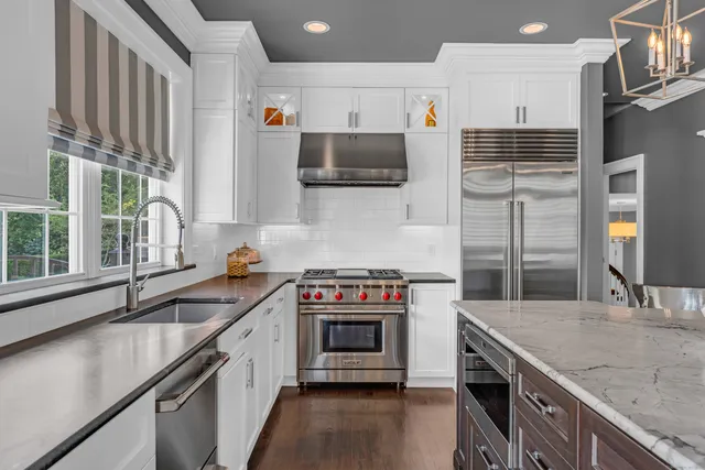 a kitchen with stainless steel appliances granite countertop a stove and a sink