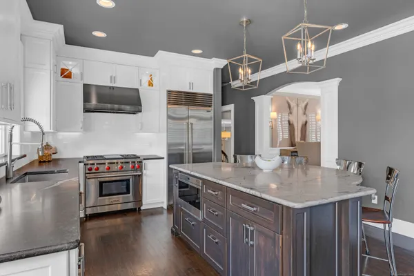 a kitchen with stainless steel appliances a stove and a sink