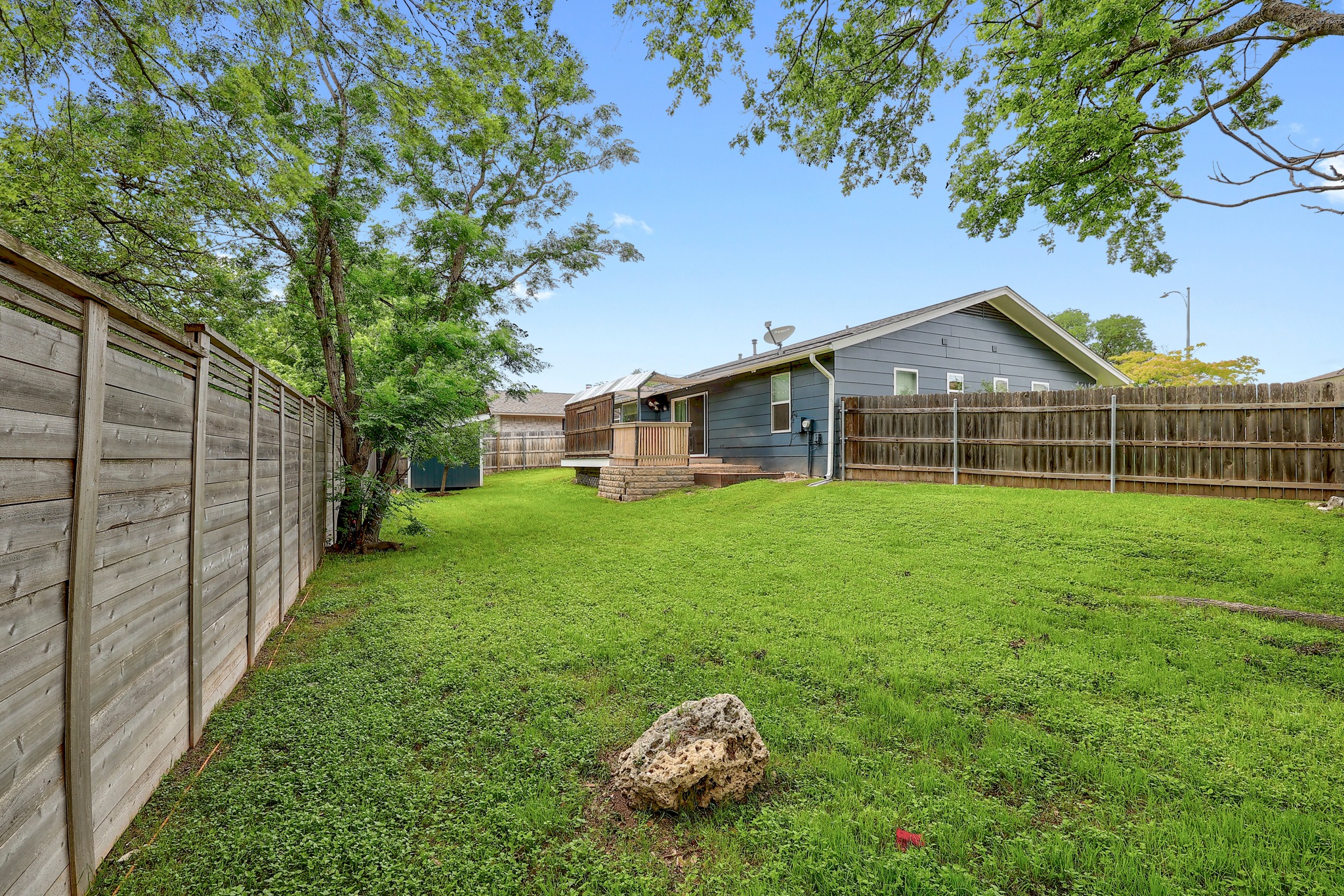 9614 Chukar Circle Austin, TX 78758 - Photo 25 of 26 A prefectly sized yard space stretches off one side of the deck providing you with ample room for pets and play.
