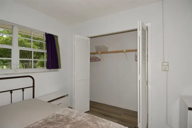 a view of a hallway with windows and cabinet
