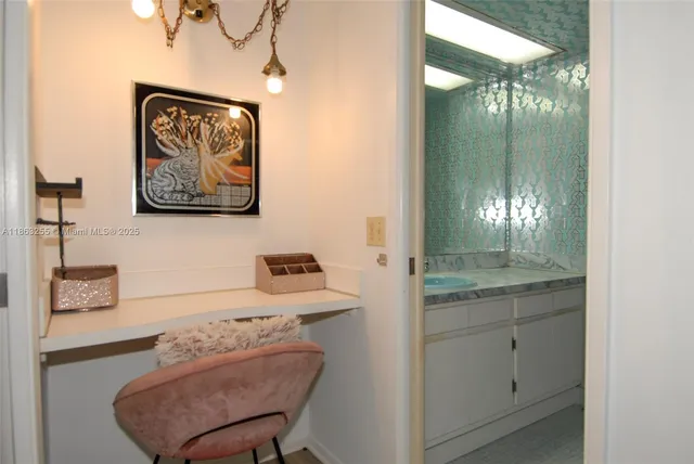 a bathroom with a sink a light fixture and a mirror