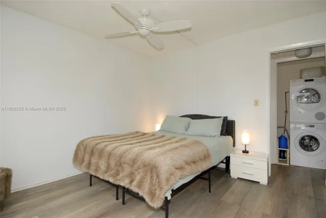 a bedroom with a bed and a lamp on the dresser