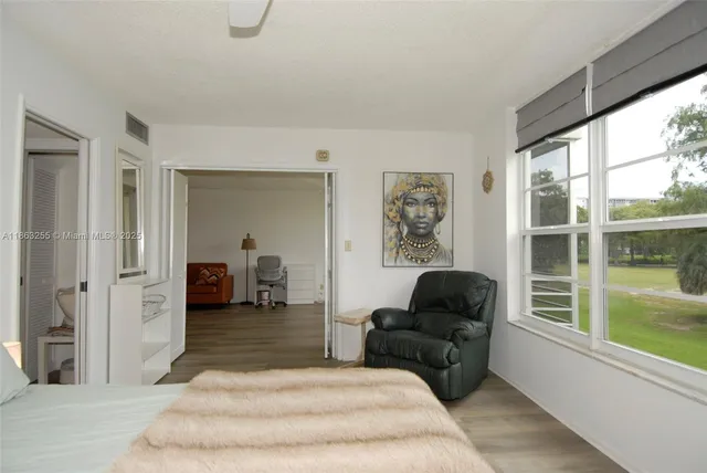 a bedroom with a bed and a large window