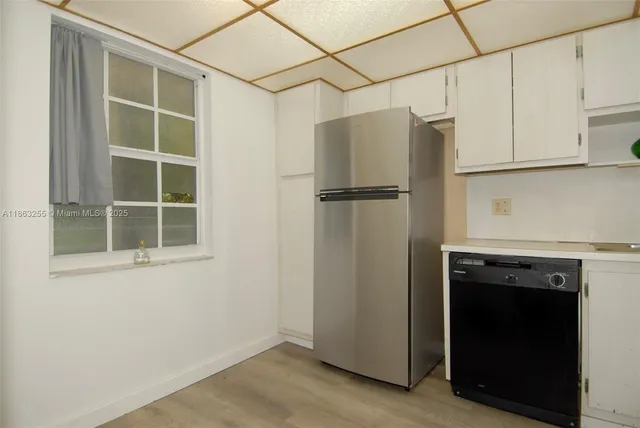 a view of a kitchen with an empty space and window