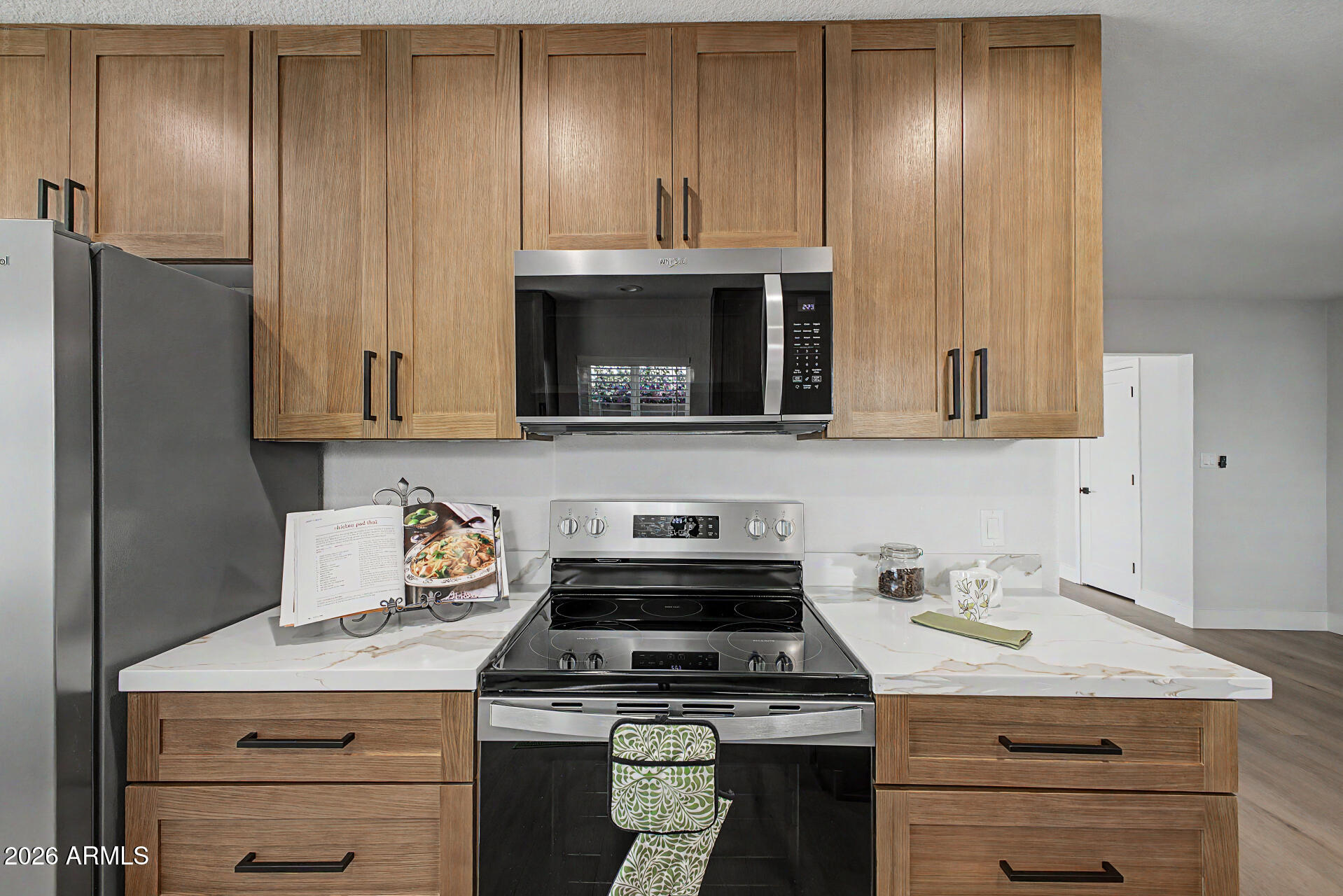 1009 West Pampa Avenue Mesa, AZ 85210 - Photo 7 of 31 a kitchen with stainless steel appliances granite countertop a stove a refrigerator and a microwave
