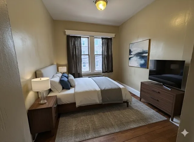 a bed room with a bed and a television