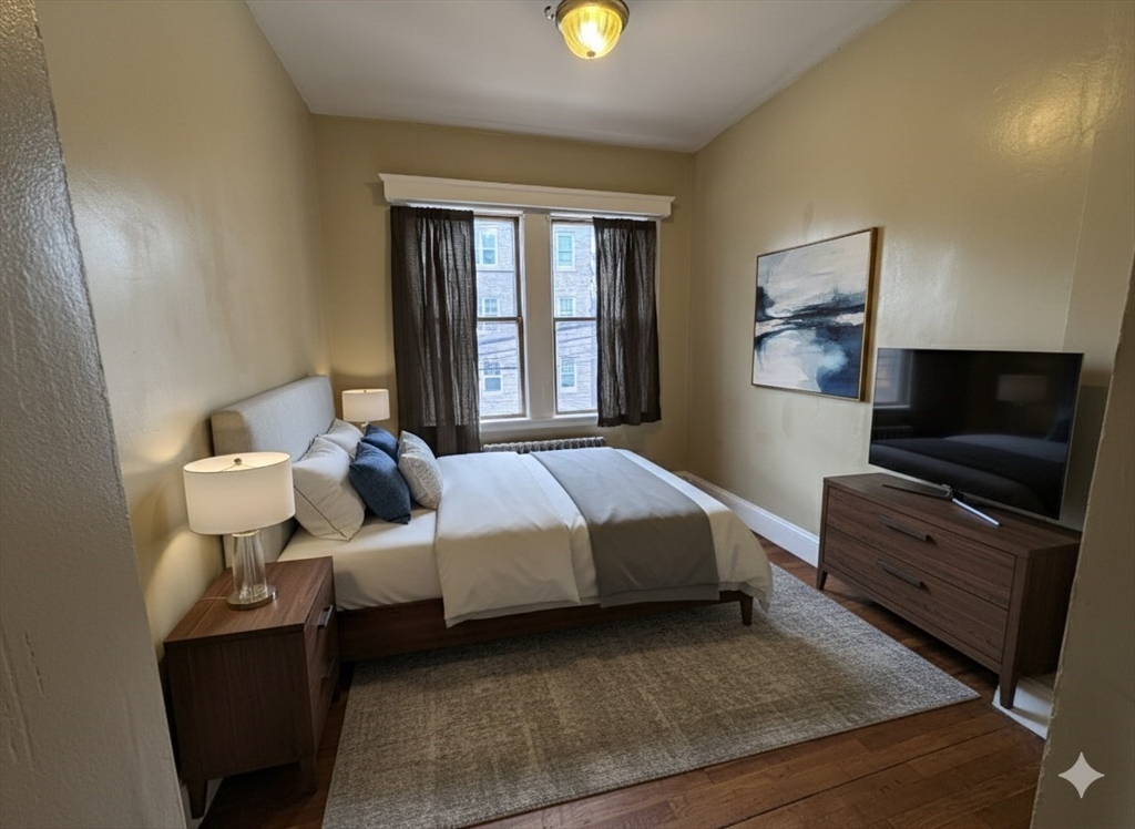 43-45 Cheney Street, Unit 3 Boston, MA 02121 - Photo 11 of 16 a bed room with a bed and a television