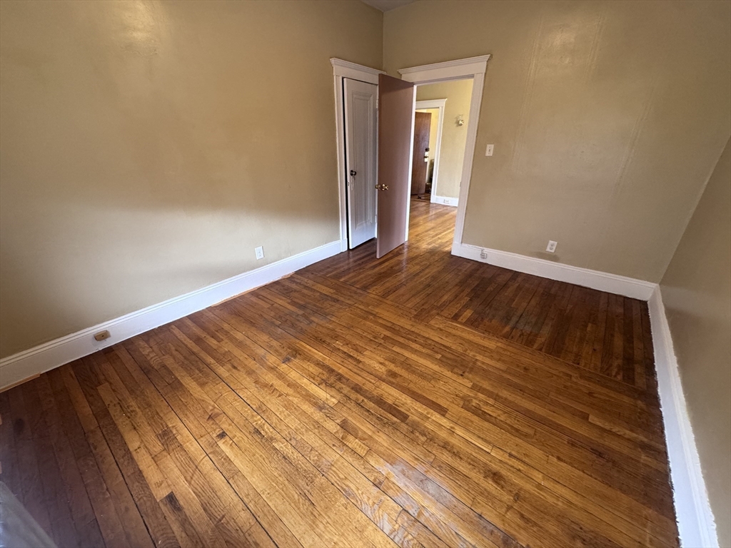 43-45 Cheney Street, Unit 3 Boston, MA 02121 - Photo 16 of 16 a view of a room with wooden floor and white walls