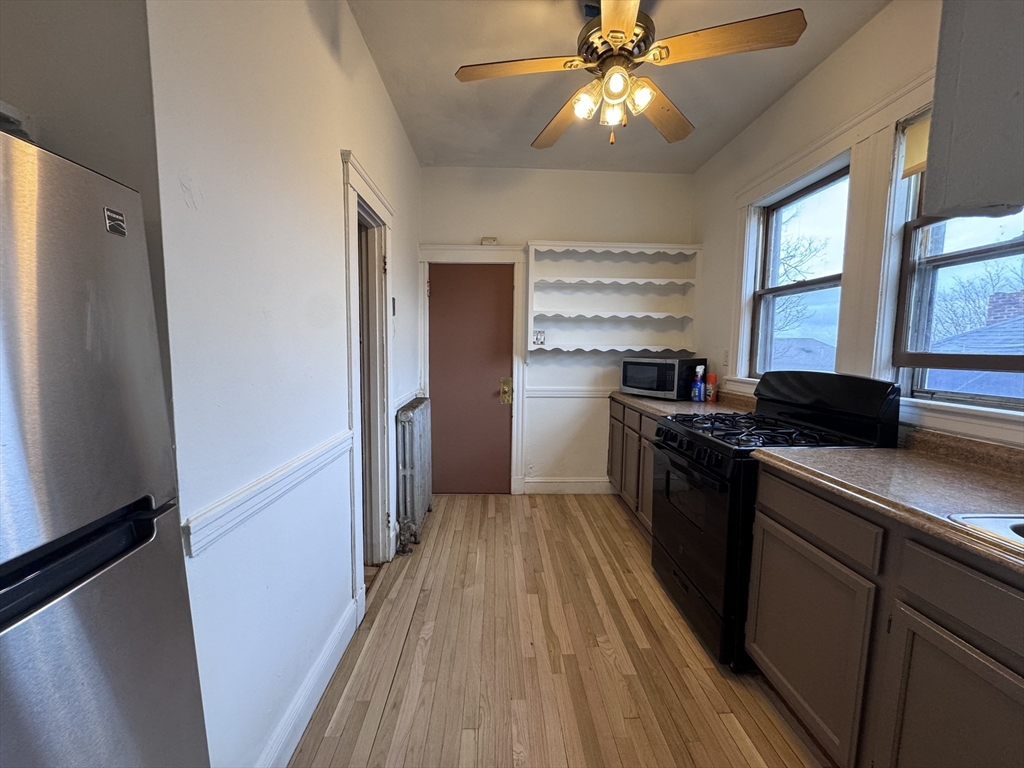 43-45 Cheney Street, Unit 3 Boston, MA 02121 - Photo 2 of 16 a kitchen with granite countertop stainless steel appliances a sink stove and refrigerator