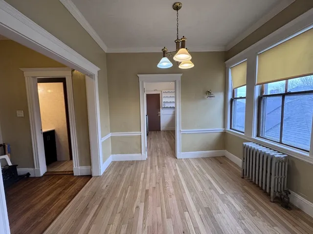 a view of a room with wooden floor and stairs