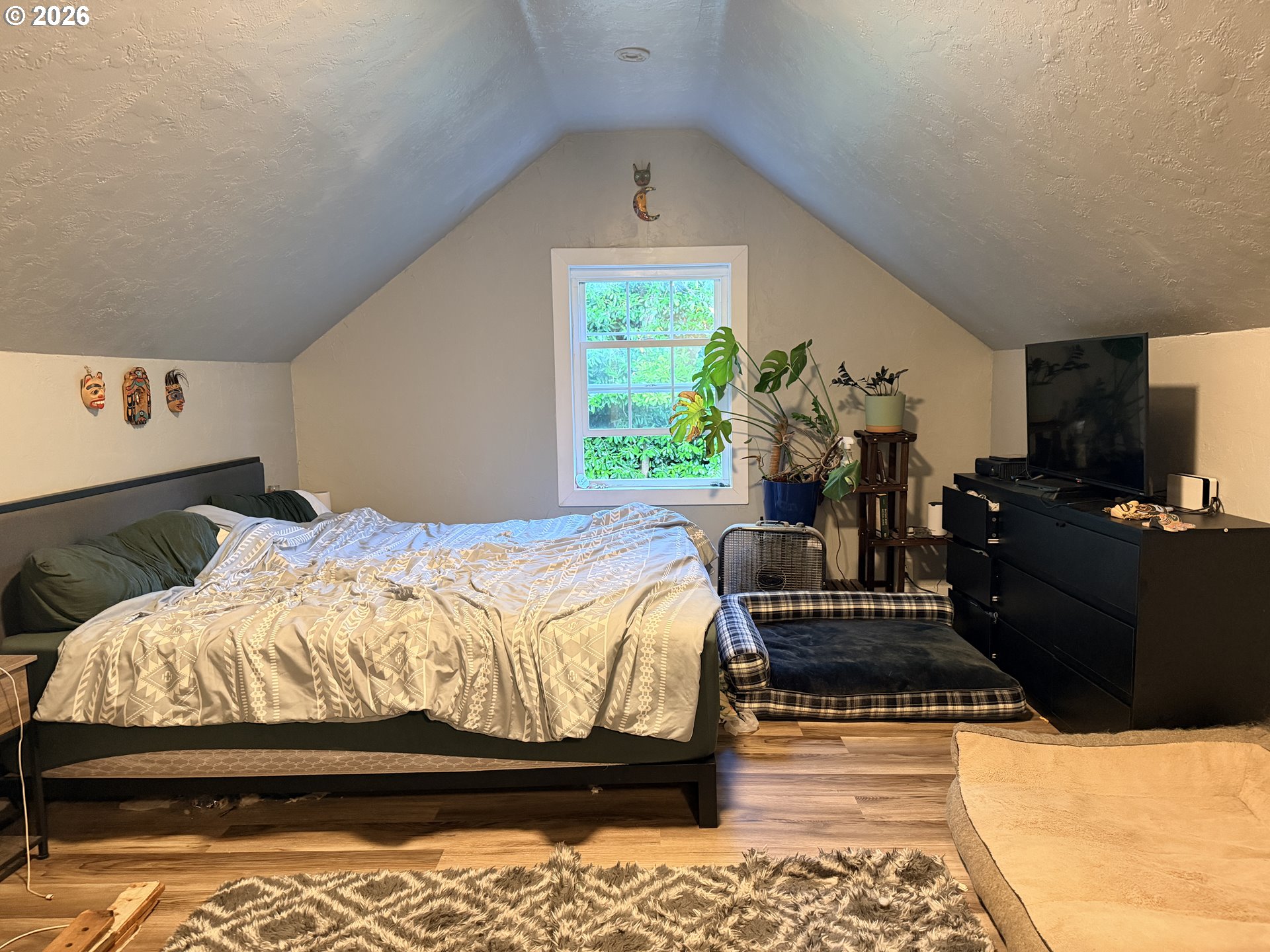 677 Southeast Moffitt Road Waldport, OR 97394 - Photo 24 of 36 a bedroom with a bed and wooden floor