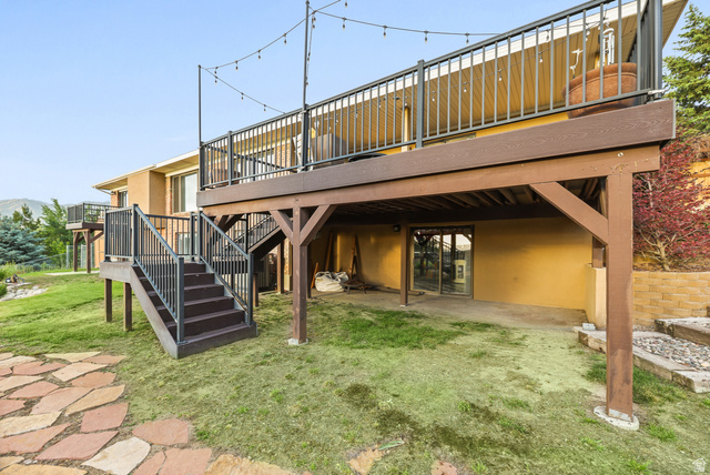 2342 Charros Road Sandy, UT 84092 - Photo 90 of 94 Multi-level elevated deck with dark railings and stairs, providing access to the grassy yard