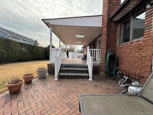 a view of a patio with table and chairs with wooden floor and plants