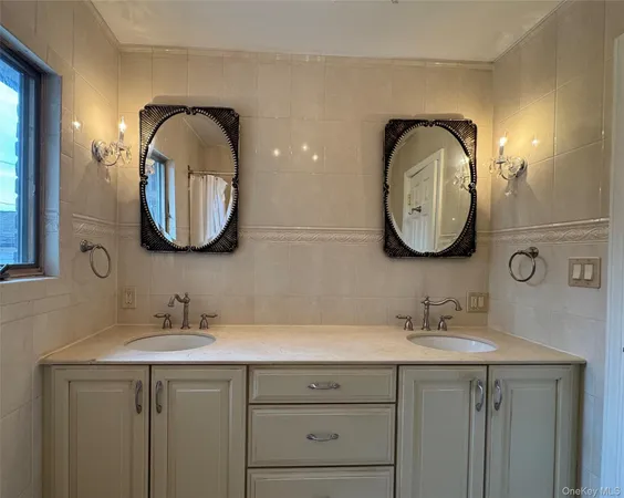a bathroom with a double vanity sink and a mirror