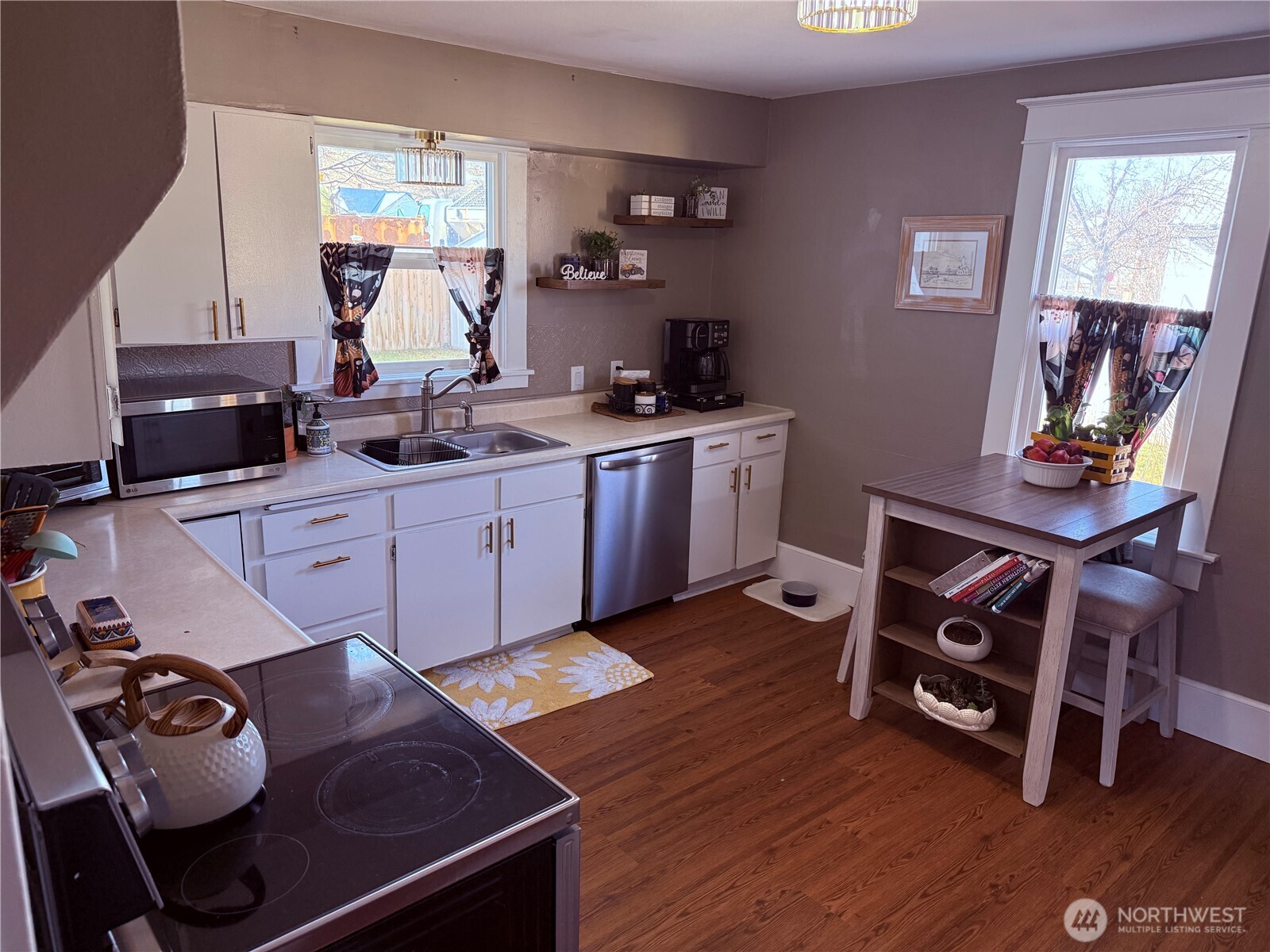 514 South Division Street Odessa, WA 99159 - Photo 13 of 40 a kitchen with a stove and wooden floor