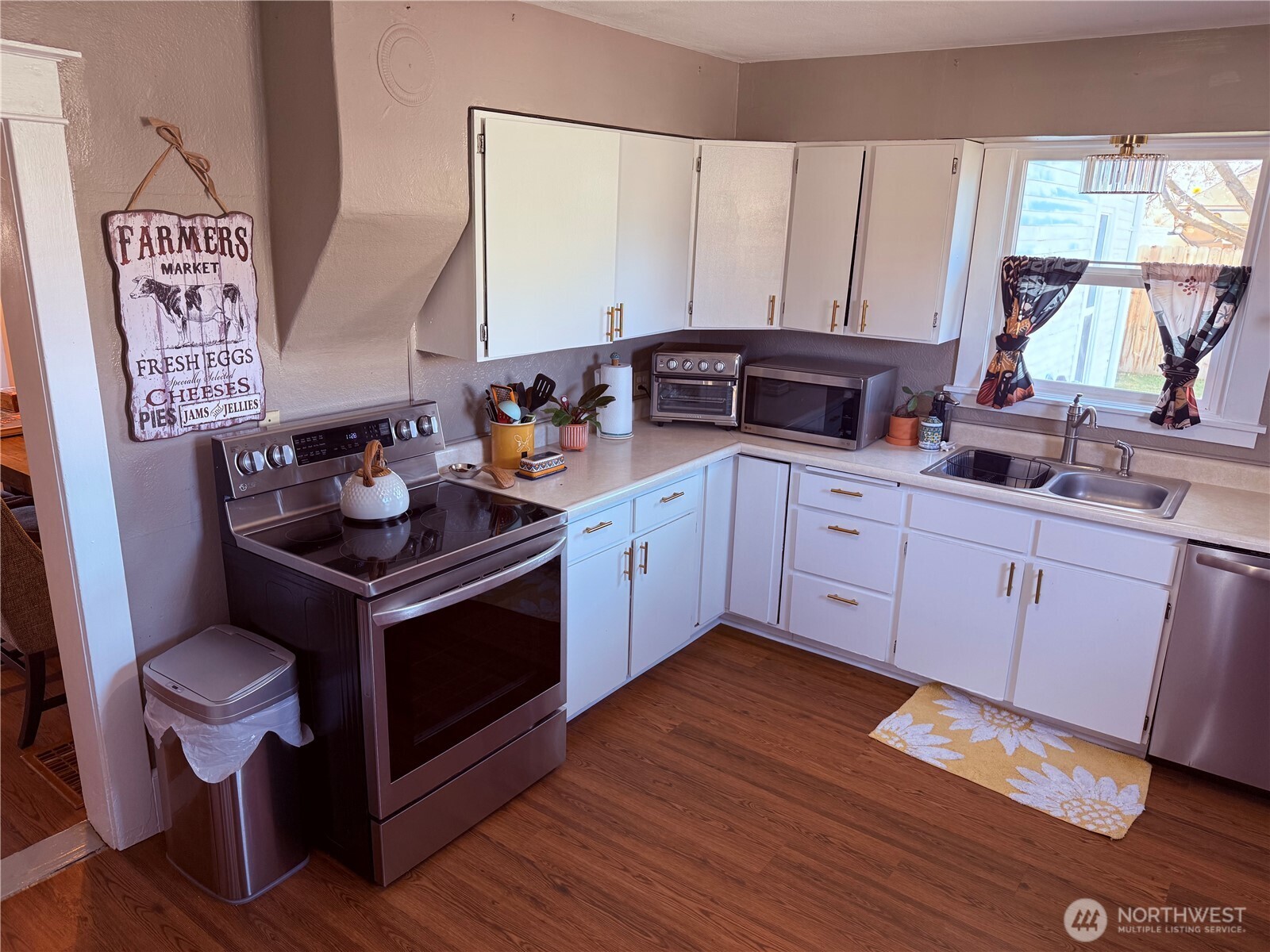 514 South Division Street Odessa, WA 99159 - Photo 14 of 40 a kitchen with a sink cabinets and wooden floor