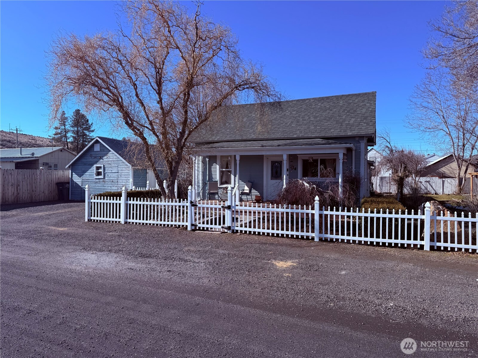 514 South Division Street Odessa, WA 99159 - Photo 39 of 40 a view of a house with a small yard and a large tree