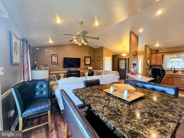 a large kitchen with a table and chairs
