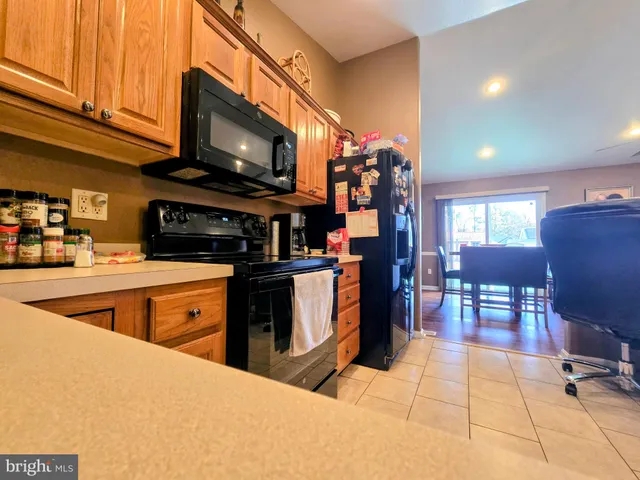 a kitchen with stainless steel appliances granite countertop a stove and a microwave with cabinets