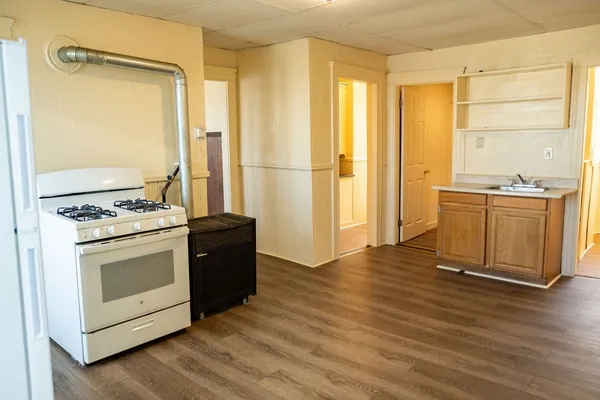 a kitchen with stainless steel appliances granite countertop a stove and a refrigerator