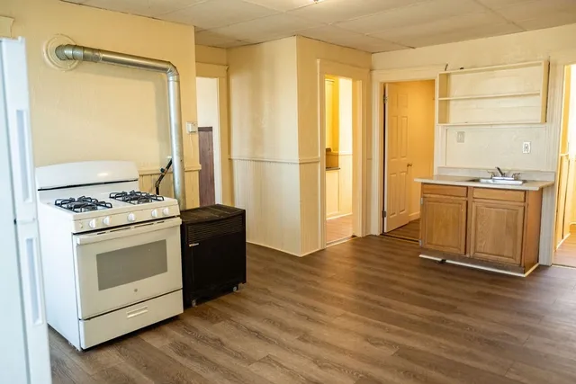 a kitchen with stainless steel appliances granite countertop a stove and a refrigerator