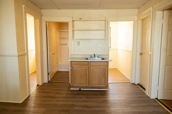 a room with a wooden floor and a window