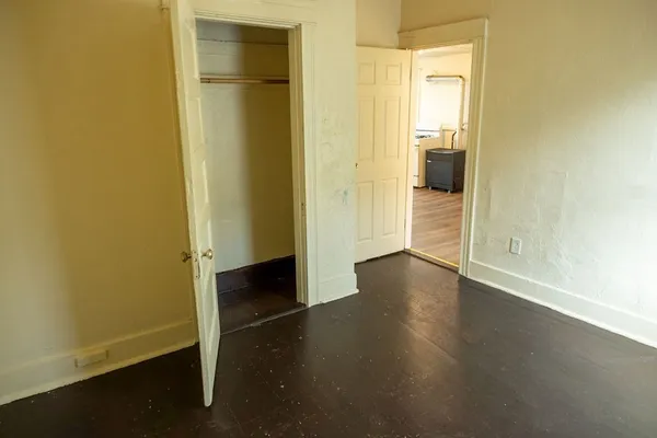 a view of a hallway with wooden floor