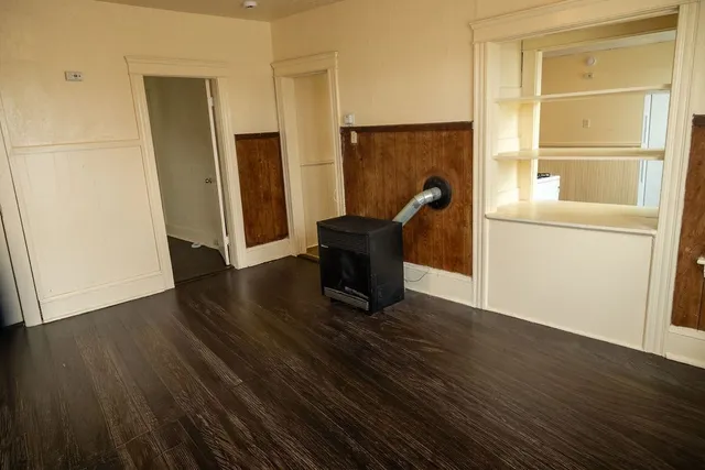 a view of a workspace with wooden floor and bathroom