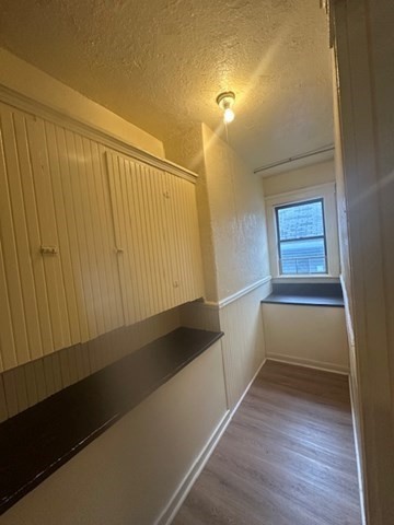 42 Dorcester, Unit 3 Worcester, MA 01604 - Photo 4 of 10 a view of an empty room with wooden floor and a window