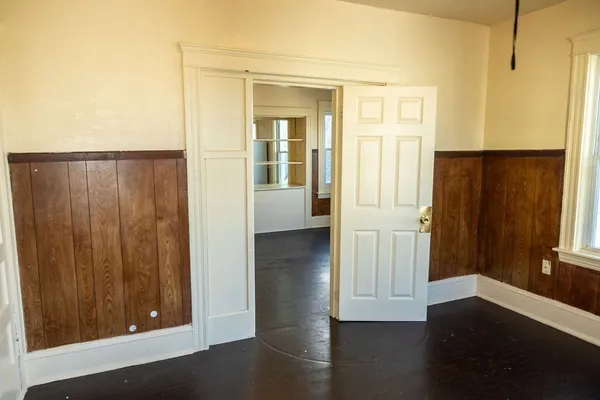 a view of a hallway with wooden floor