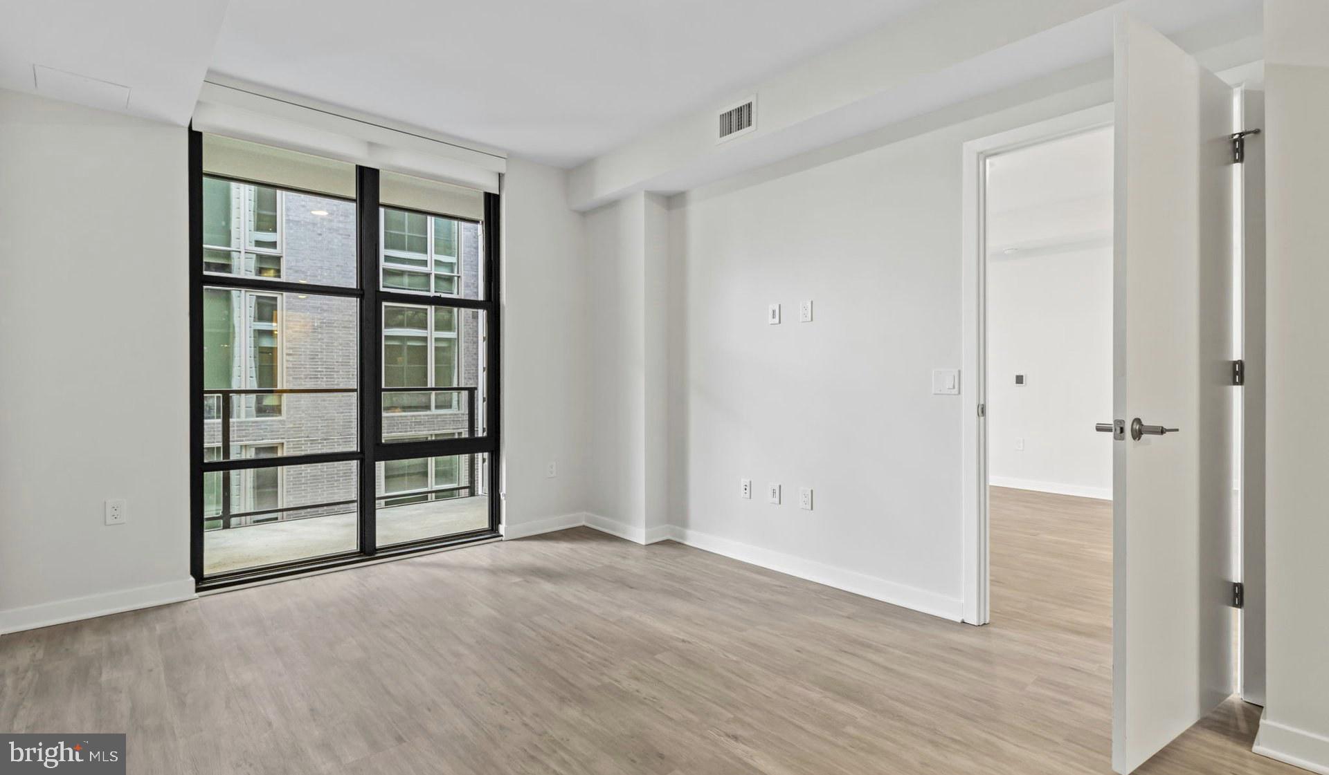 4000 Wisconsin Avenue Northwest, Unit 4K236 Washington, DC 20016 - Photo 22 of 54 wooden floor and windows in a room