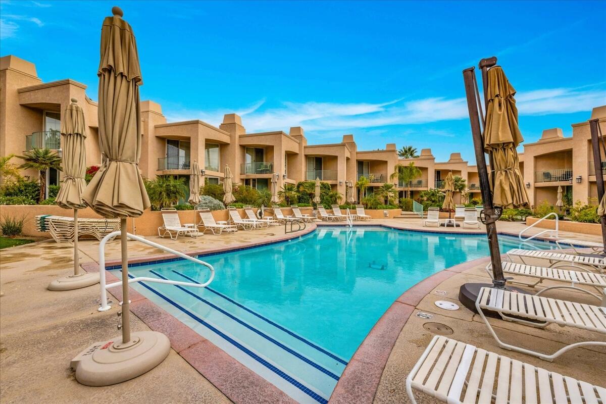 1555 North Chaparral Road, Unit 334 Palm Springs, CA 92262 - Photo 1 of 36 a view of a patio with swimming pool table and chairs