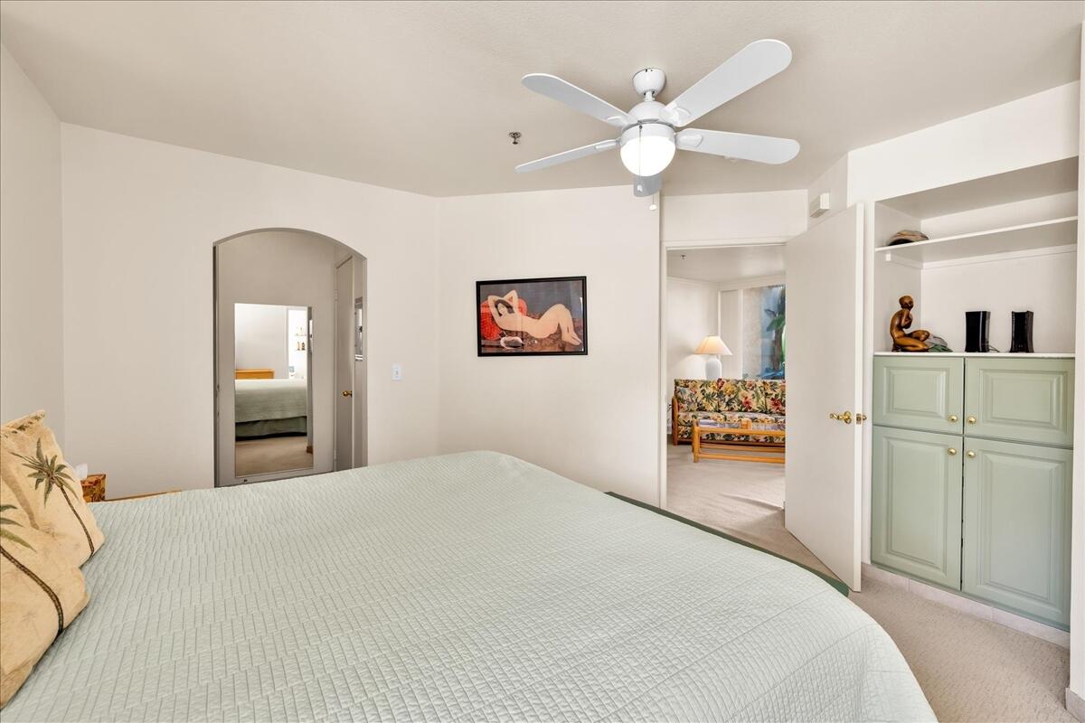 1555 North Chaparral Road, Unit 334 Palm Springs, CA 92262 - Photo 15 of 36 a bedroom with a bed and a chandelier