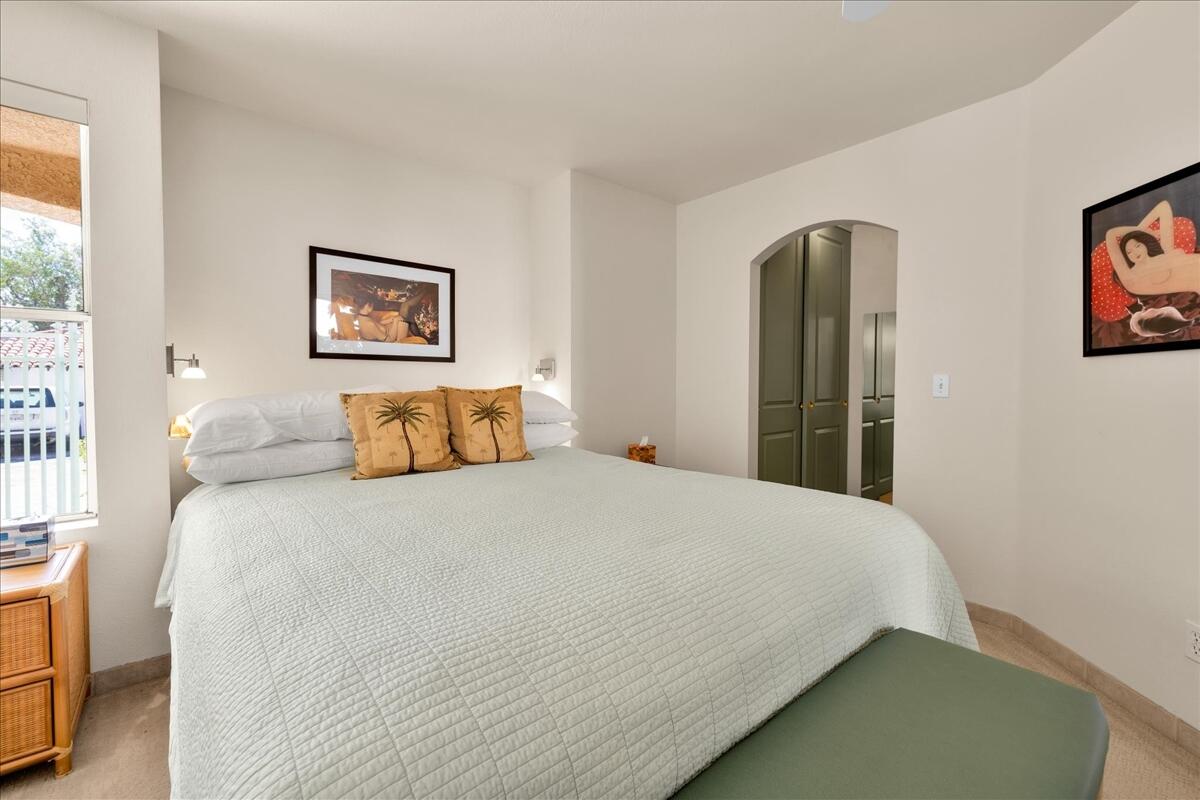1555 North Chaparral Road, Unit 334 Palm Springs, CA 92262 - Photo 16 of 36 a bedroom with a bed and painting on the wall