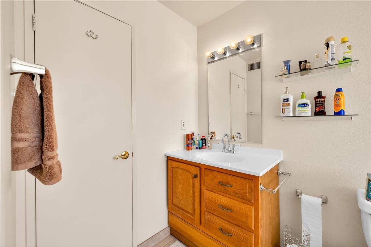 1555 North Chaparral Road, Unit 334 Palm Springs, CA 92262 - Photo 19 of 36 a bathroom with a sink vanity and a mirror