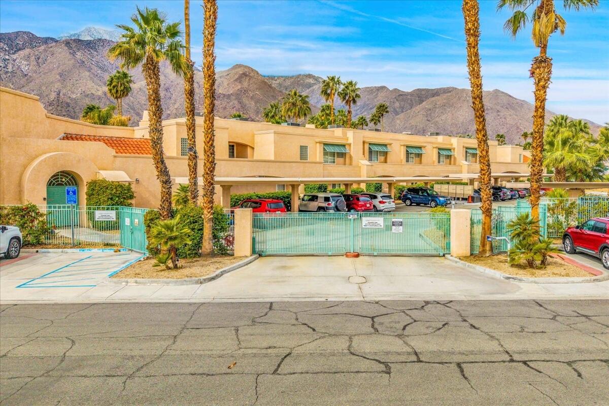 1555 North Chaparral Road, Unit 334 Palm Springs, CA 92262 - Photo 26 of 36 a view of a brick building with a yard