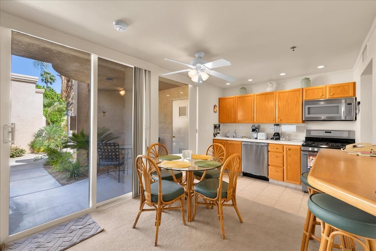 1555 North Chaparral Road, Unit 334 Palm Springs, CA 92262 - Photo 9 of 36 a dining area with furniture and a kitchen view