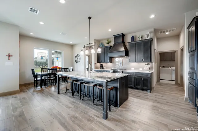 a large kitchen with a table and chairs