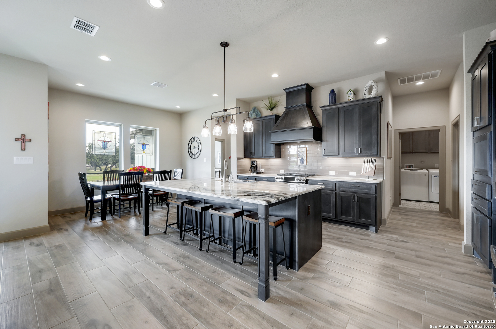 a large kitchen with a table and chairs