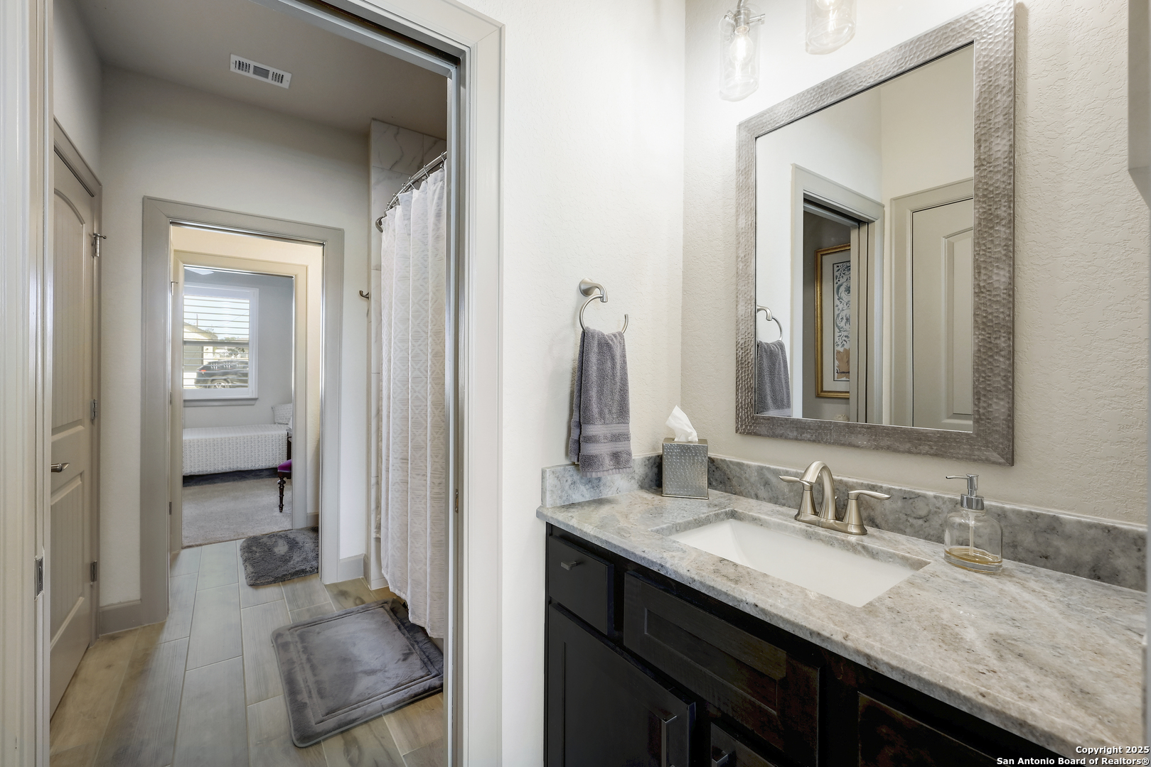 119 Hiram Cook Blanco, TX 78606 - Photo 11 of 20 a en suite bathroom with a granite countertop sink and a mirror