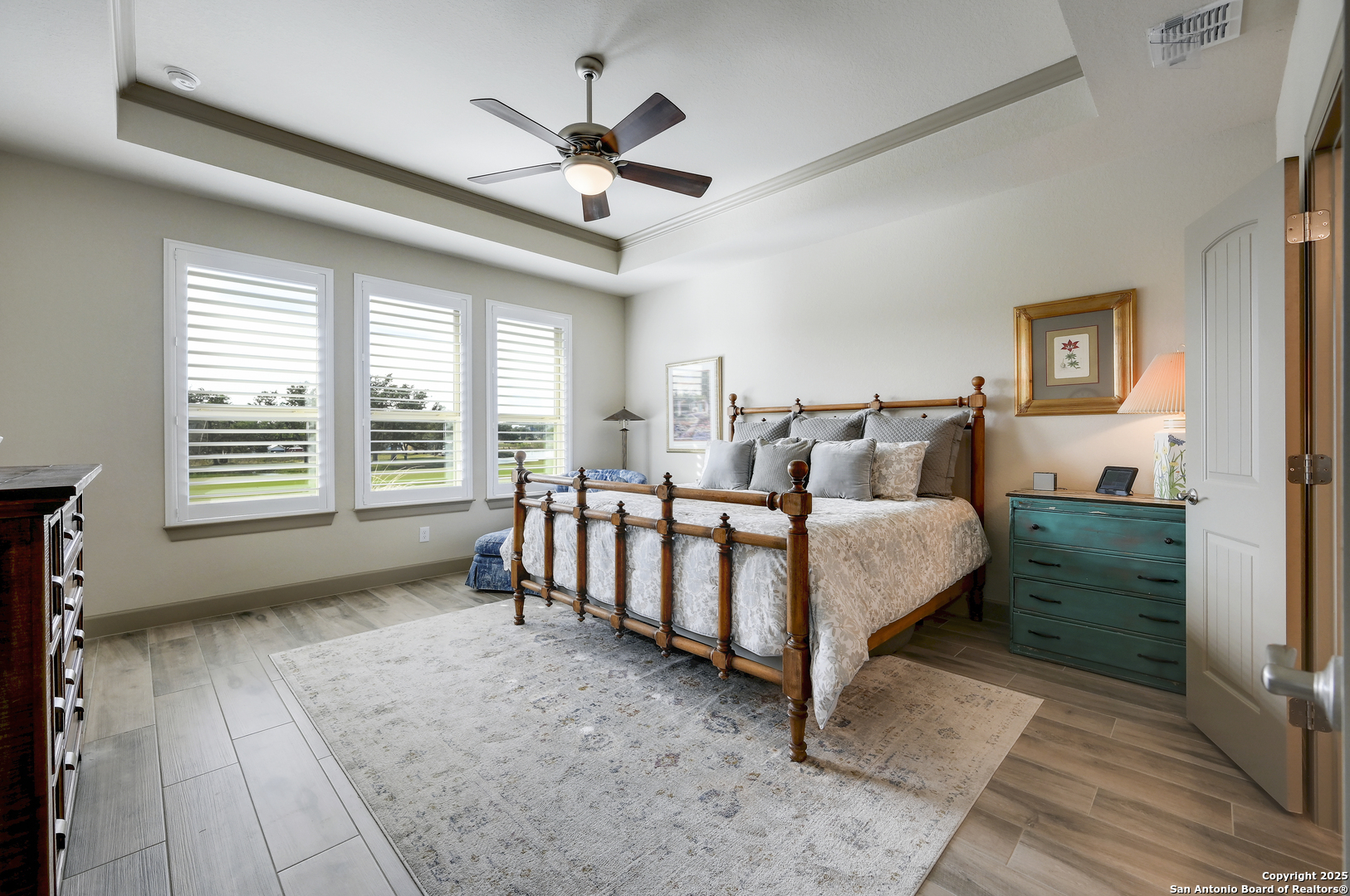 119 Hiram Cook Blanco, TX 78606 - Photo 7 of 20 a spacious bedroom with a bed and a chandelier