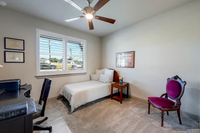a bed sitting in a bedroom next to a window