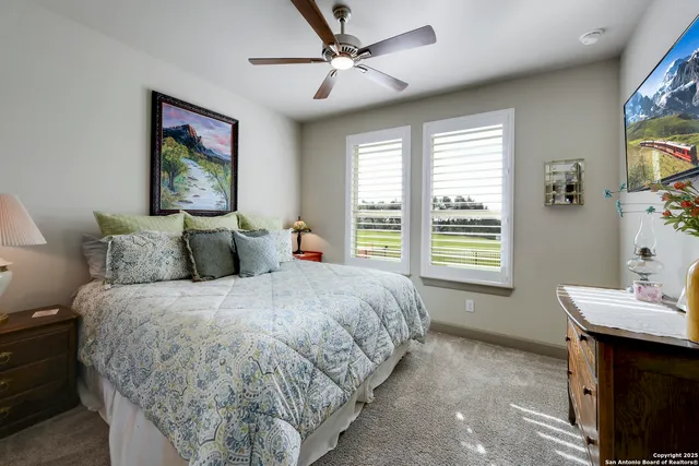 a en suite bathroom with a granite countertop sink and a mirror